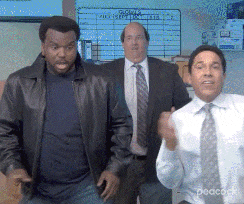 Three characters from The Office—Darryl, Kevin, and Oscar—dancing together in celebration