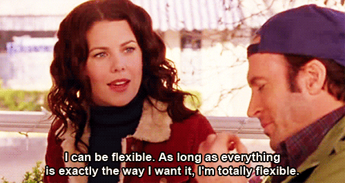 A woman is talking to the man next to her, who is eating something. Text on the screen reads, "I can be flexible. As long as everything is exactly the way I want it. I'm totally flexible."