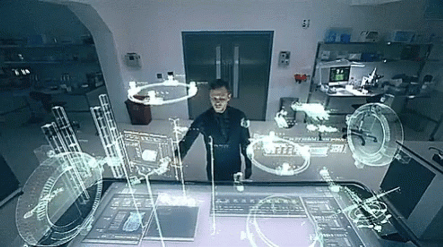Person standing in a high-tech lab surrounded by holographic screens and interactive displays, manipulating digital images with gestures