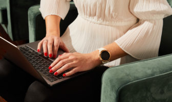 An image of a woman typing on her laptop