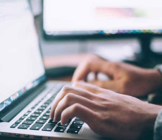 hands typing on a keyboard
