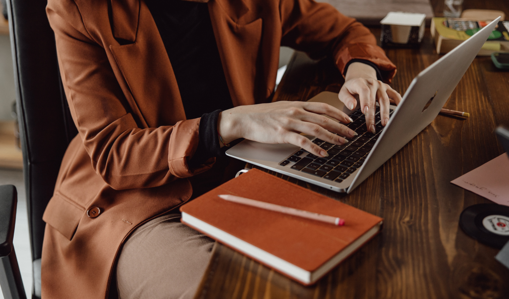 woman typing on her laptop at work