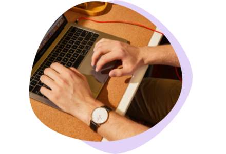 An image of hands typing on a laptop
