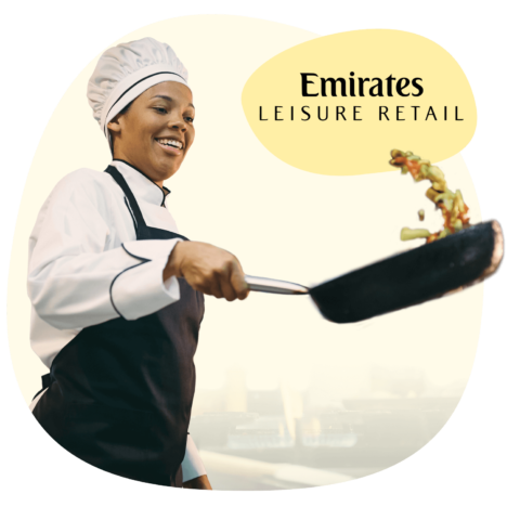An image of a chef flipping her pan, with the logo of Emirates Leisure Retail on the upper right hand side
