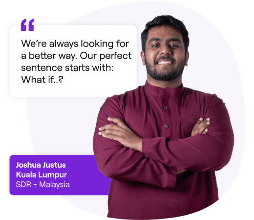 A professional photo of Joshua Justus, an SDR (Sales Development Representative) based in Kuala Lumpur, Malaysia. There is a quote in a speech bubble next to him reads: “We’re always looking for a better way. Our perfect sentence starts with: What if..?”