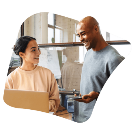 An image of a male and female colleague discussing something on a laptop