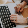 View of someone's hands working at a laptop