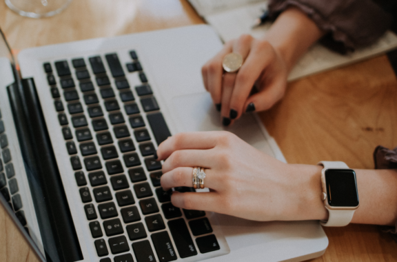 View of someone's hands working at a laptop