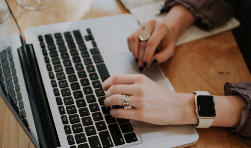 View of someone's hands working at a laptop