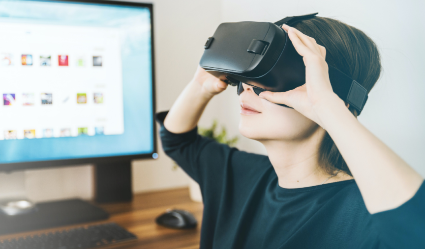 Person with AR headset sitting in front of screen