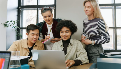 group of diverse employees sitting around the table discussing