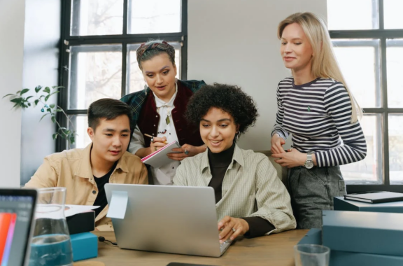 group of diverse employees sitting around the table discussing