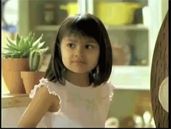 GIF of a young girl shrugging and saying, 'Why not both?' with a playful expression