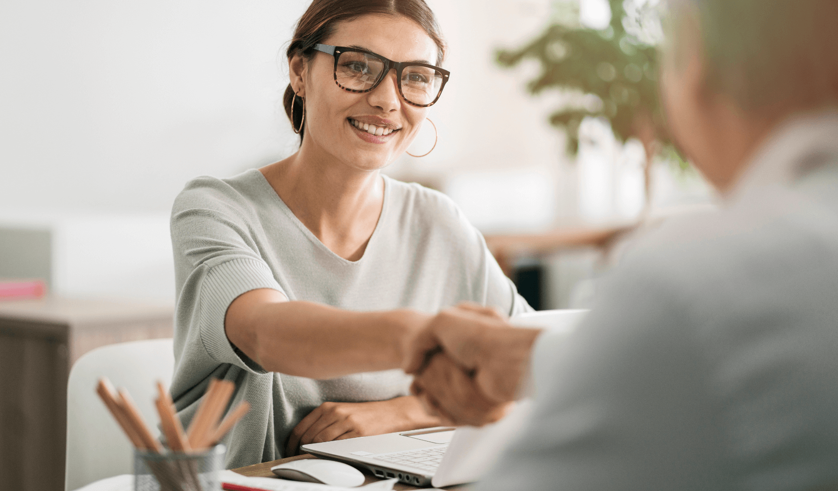 woman shaking someone else's hand