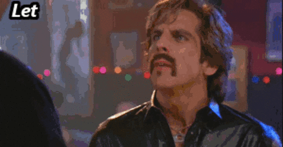 A man with a mustache and shaggy hair appears surprised and looks upward, wearing a shiny black shirt, inside a dimly lit room with colorful lights blurred in the background. Text reads: "Let me hit you with some KNOWLEDGE".
