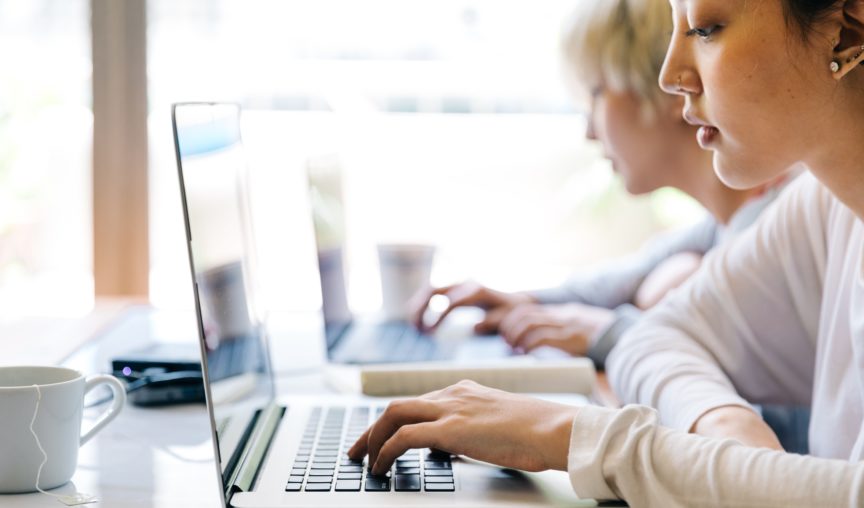 woman typing on her laptop