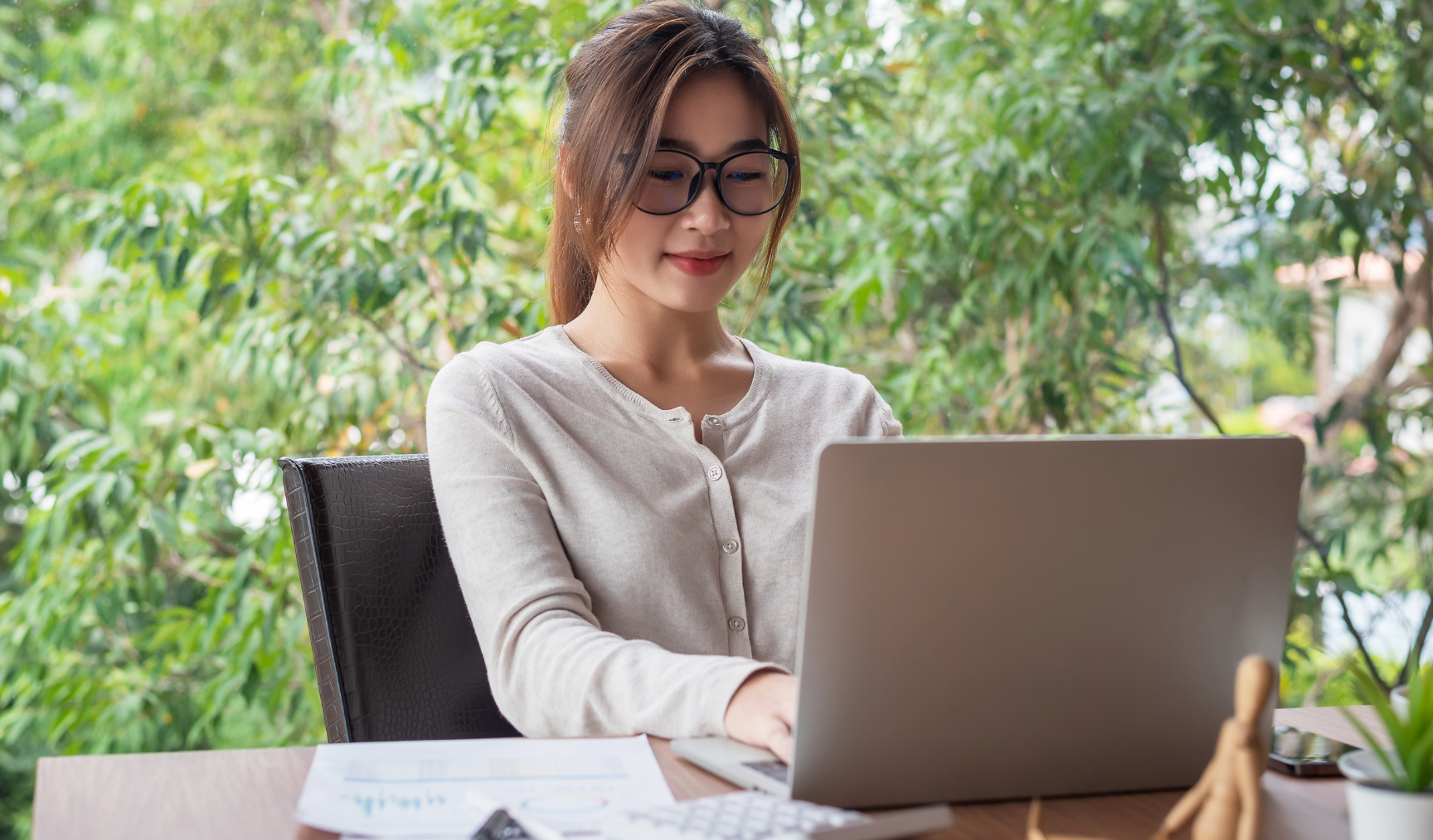 woman typing on her laptop and smiling