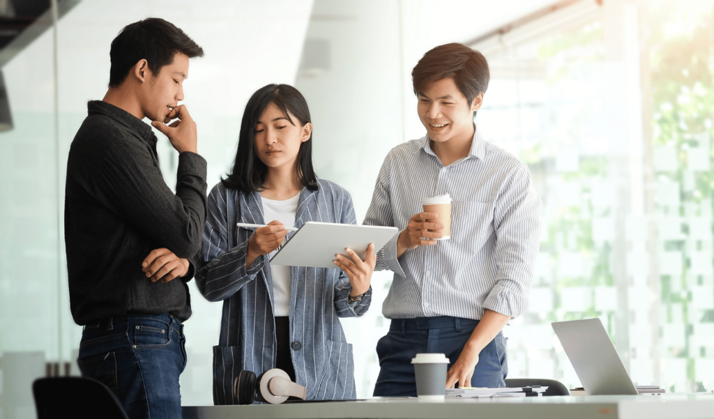 three colleagues discussing work matters