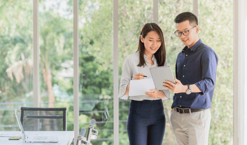 two colleagues discussing something that is being shown on a tablet