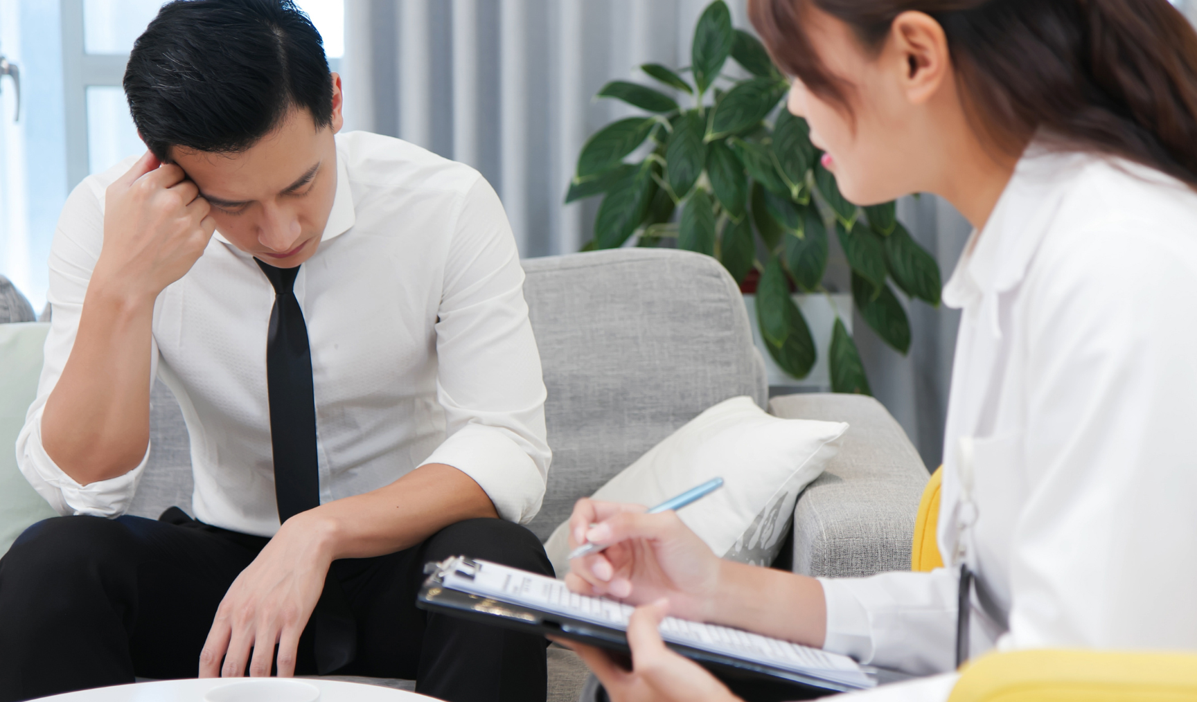 office worker talking to a counsellor with his head down