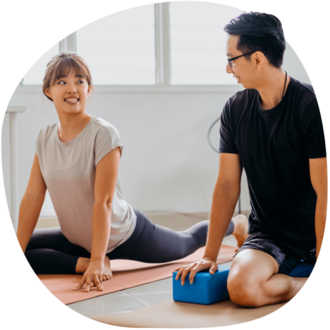 An image of two colleagues doing yoga together