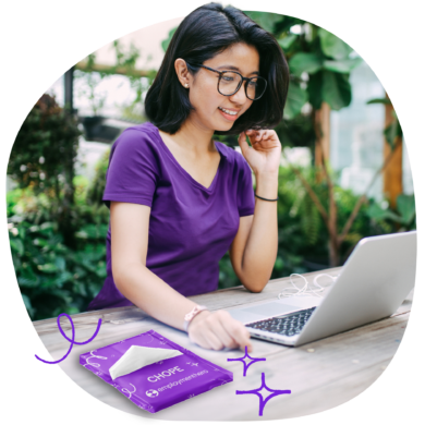 An image of a woman in violet, smiling as she's staring on the laptop with some decorative doodles on the side