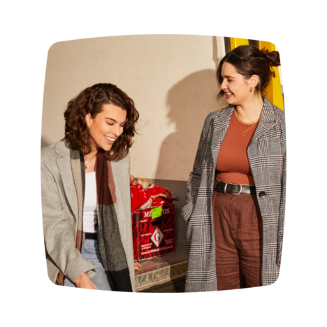An image of two female colleagues smiling and talking