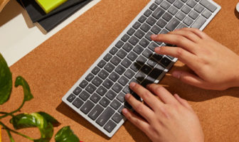 An overhead image of hands typing on a keyboard