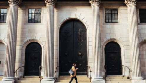 Someone walking past the Bank of England building