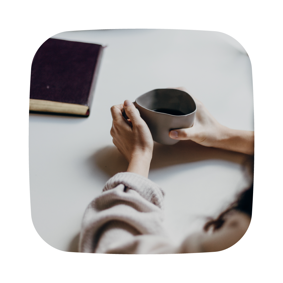 hands holding to a cup of coffee