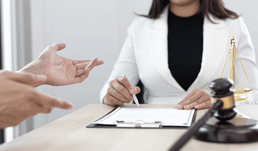image of a woman sitting at a desk with documents