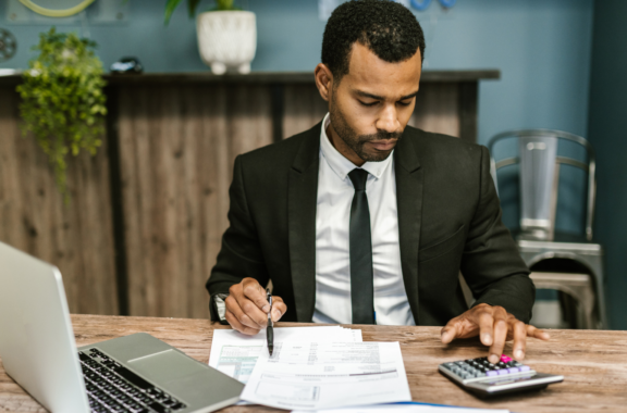 man calculating at his desk