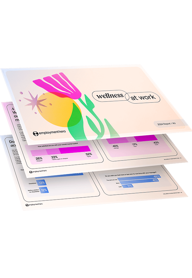 A stack of overlapping documents with the top page titled 'Wellness at Work,' featuring a colorful illustration of a flower