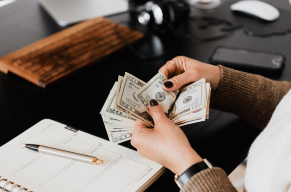 a woman handling money - federal budget