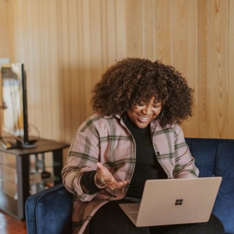 woman smiling at her laptop