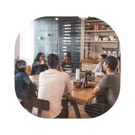 Group of people in a modern office space having a meeting around a table