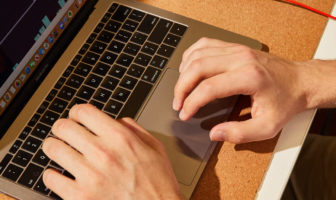 Hands on a laptop