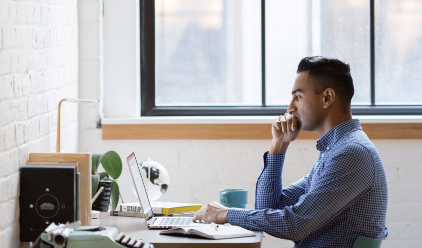 image of a man at his desk looking at National Employment Standards