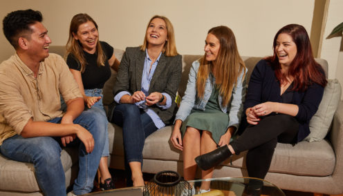 People on couch laughing