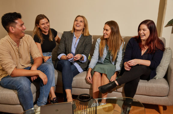 People on couch laughing