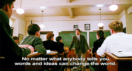 A teacher stands in front of a blackboard, addressing students seated in classroom desks. Text: "No matter what anybody tells you, words and ideas can change the world."
