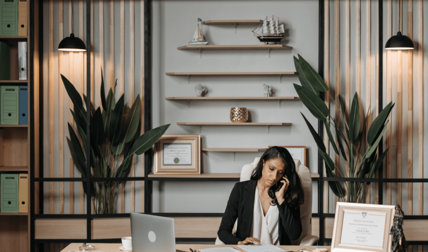 image of a woman at her desk on the phone