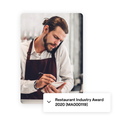 Image of a restaurant employee in an apron, taking notes while talking on the phone. A label below reads 'Restaurant Industry Award 2020 [MA000119]' indicating industry-specific regulations