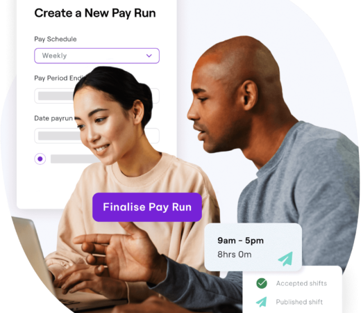 Man and woman working on a computer, setting up a pay run in payroll software