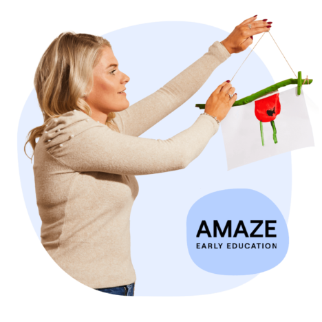 A woman engaging in an early education activity, holding a child’s artwork of a flower with a green stem and red petals. The text 'AMAZE Early Education' is displayed on a light blue background.