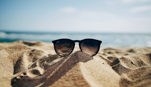 sunglasses on a beach - employers encourage annual leave