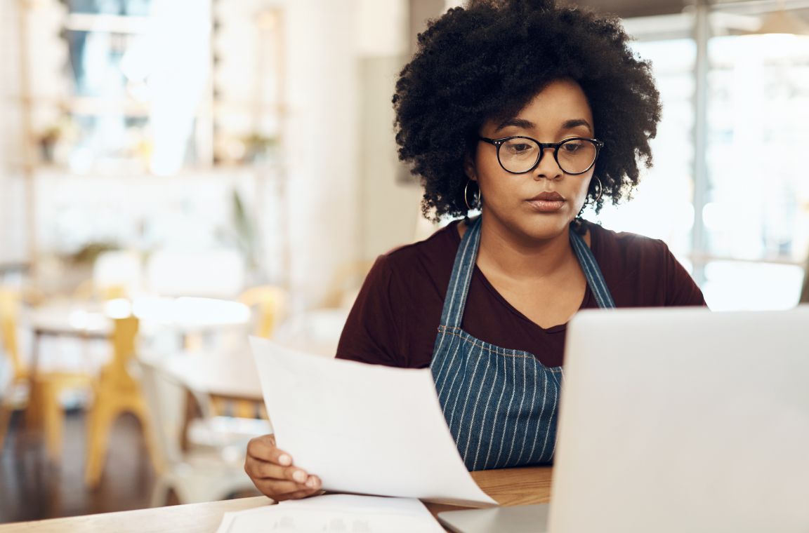 image of a worker looking at paperwork looking to streamline their payroll processes