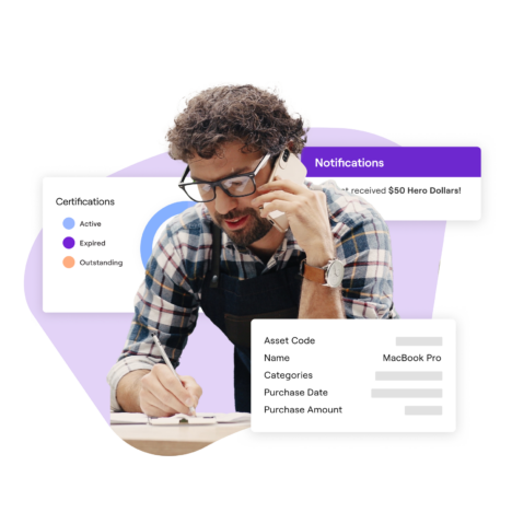This image features a man with curly hair, glasses, and an apron, writing while talking on the phone. Surrounding him are overlay elements: a "Notifications" box showing he received "$60 Hero Dollars," a "Certifications" status chart with categories like "Active," "Expired," and "Outstanding," and an "Asset" table listing details such as an item named "MacBook Pro."