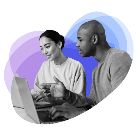 Two people collaborating on a laptop