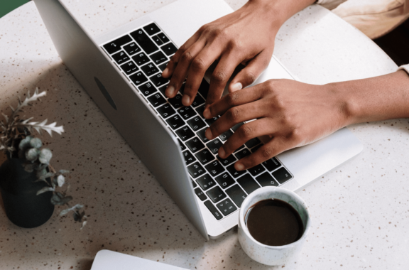image of a person typing on a laptop